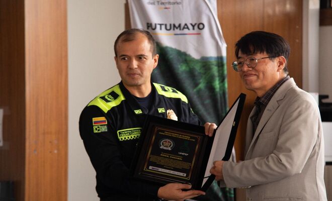 Un policía sosteniendo una placa con una persona