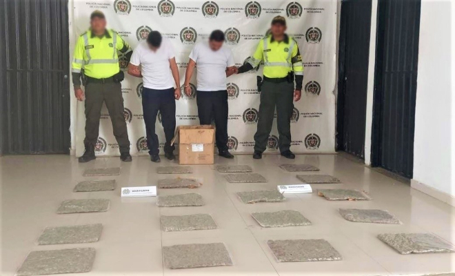 Personas capturadas-policías custodiando