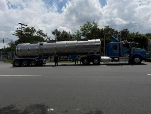 Dos polic&iacute;as al lado de un tractocami&oacute;n 